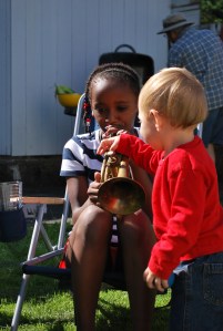 Josie is already mastering the trumpet, while Henry helps.