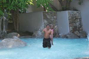 The kids splashing in the wading pool.