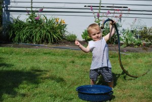 Henry wrestling the snake in Grandma's yard.